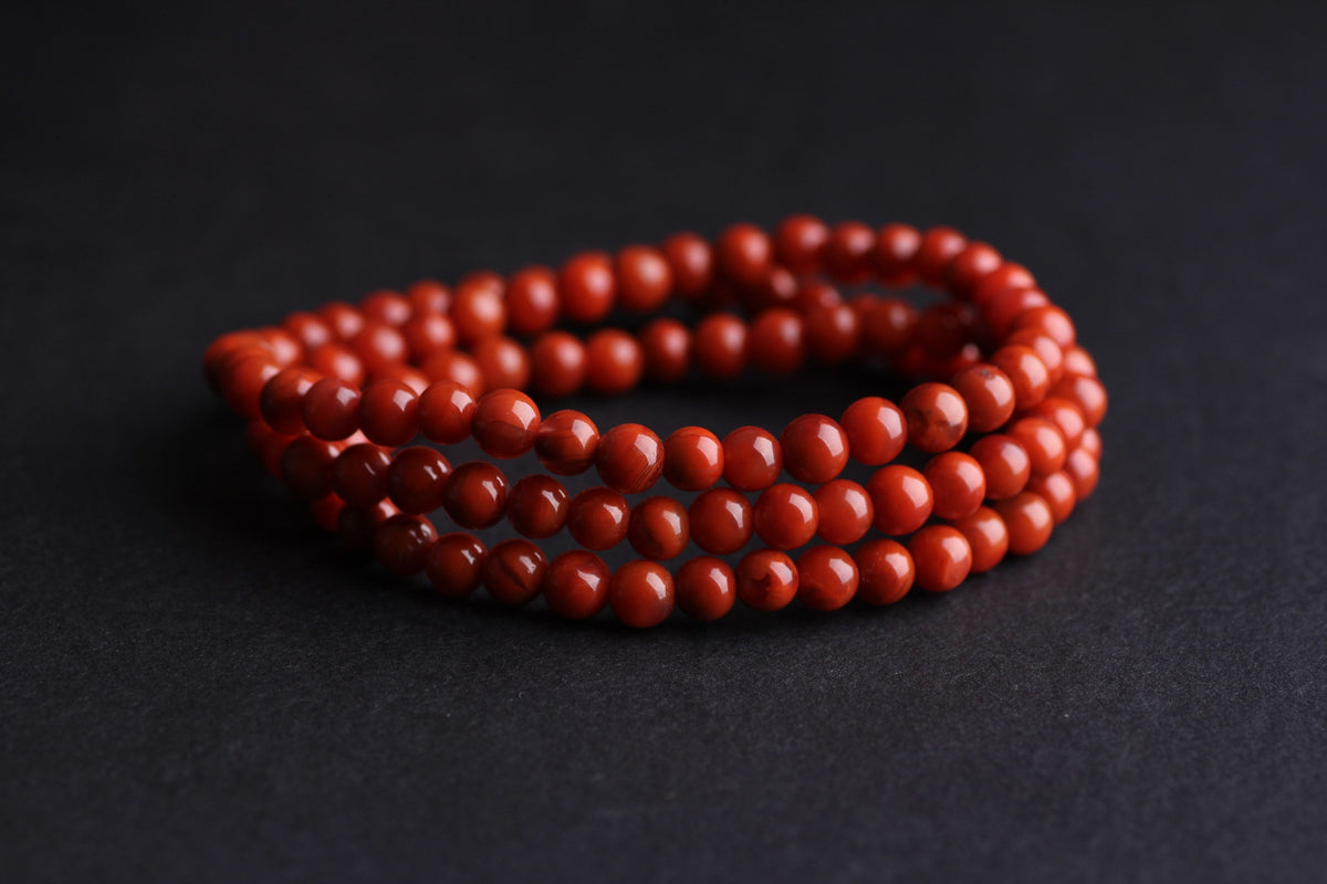 Red chalcedony and agate showing differences in tone, polish and translucency