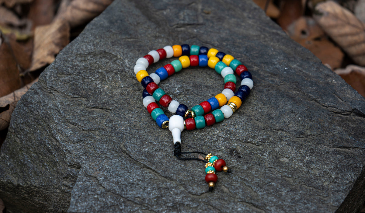 Tactile jewelry with smooth beads, carved details and surfaces made to be handled