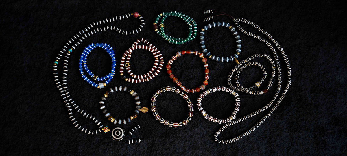 A coordinated jewelry wardrobe mixing stone, wood and metal in wearable proportions