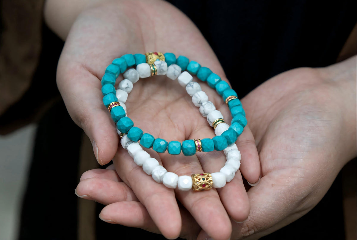 Layered stone necklaces arranged at different lengths and scales