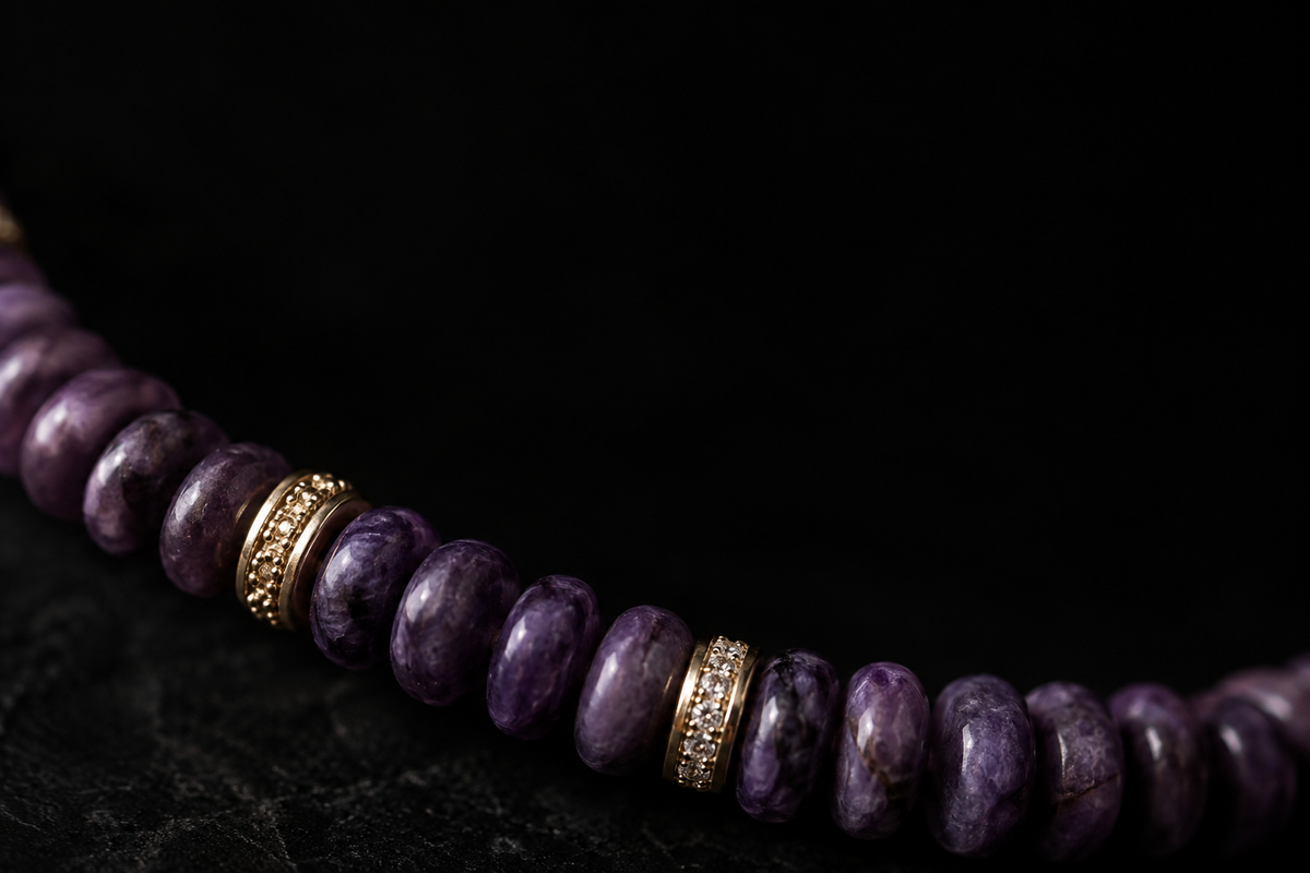 Macro editorial view of purple sugilite disc beads with 18K gold-plated details on a near-black surface.