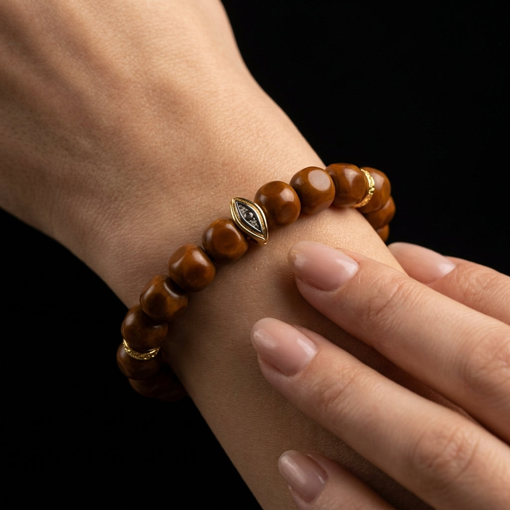 A person rolling the 10mm Walnut Wood beads between their fingers, using the warm, organic texture to clear mental fog and regain focus.