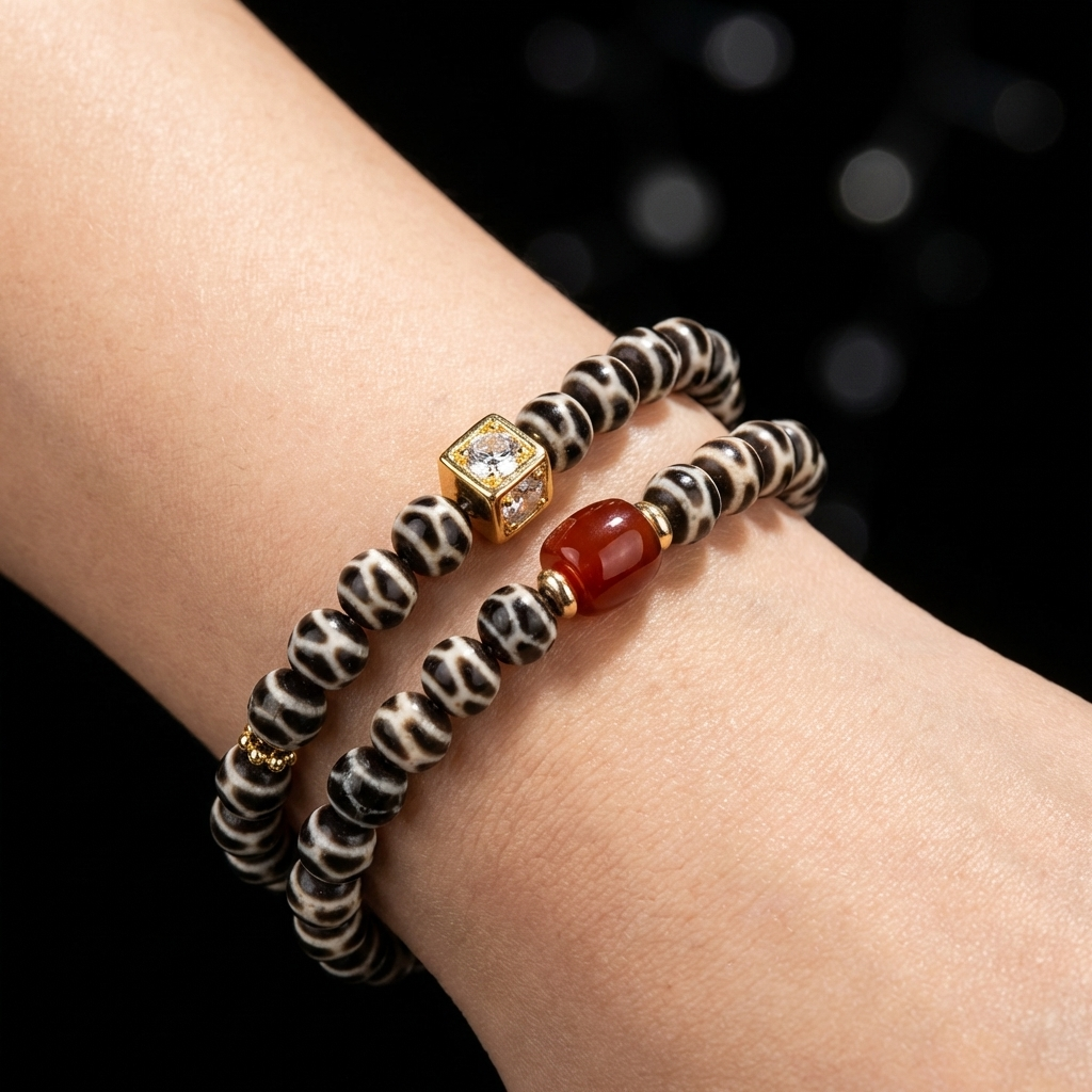  Woman wearing the Defined Path double-wrap Agate focus bracelet on her wrist, showcasing the intricate patterned stones and sharp gold cube against her skin.