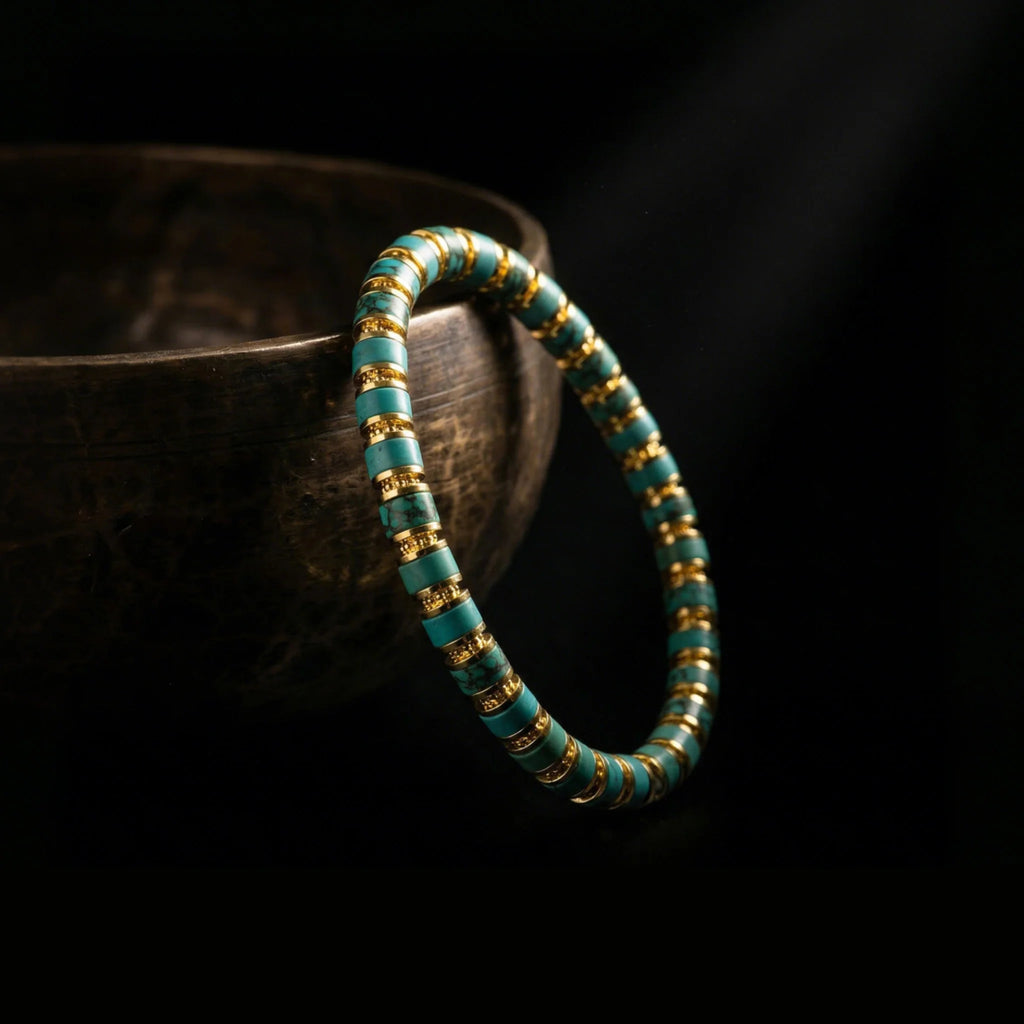 The Matrix Turquoise grounding bracelet draped near an antique singing bowl, representing the 1,900-meter acoustic purification ritual by Jambhala.